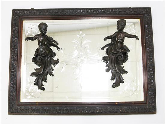 An Edwardian wall mirror with bronzed copper amorini appliques 30 x 40in.